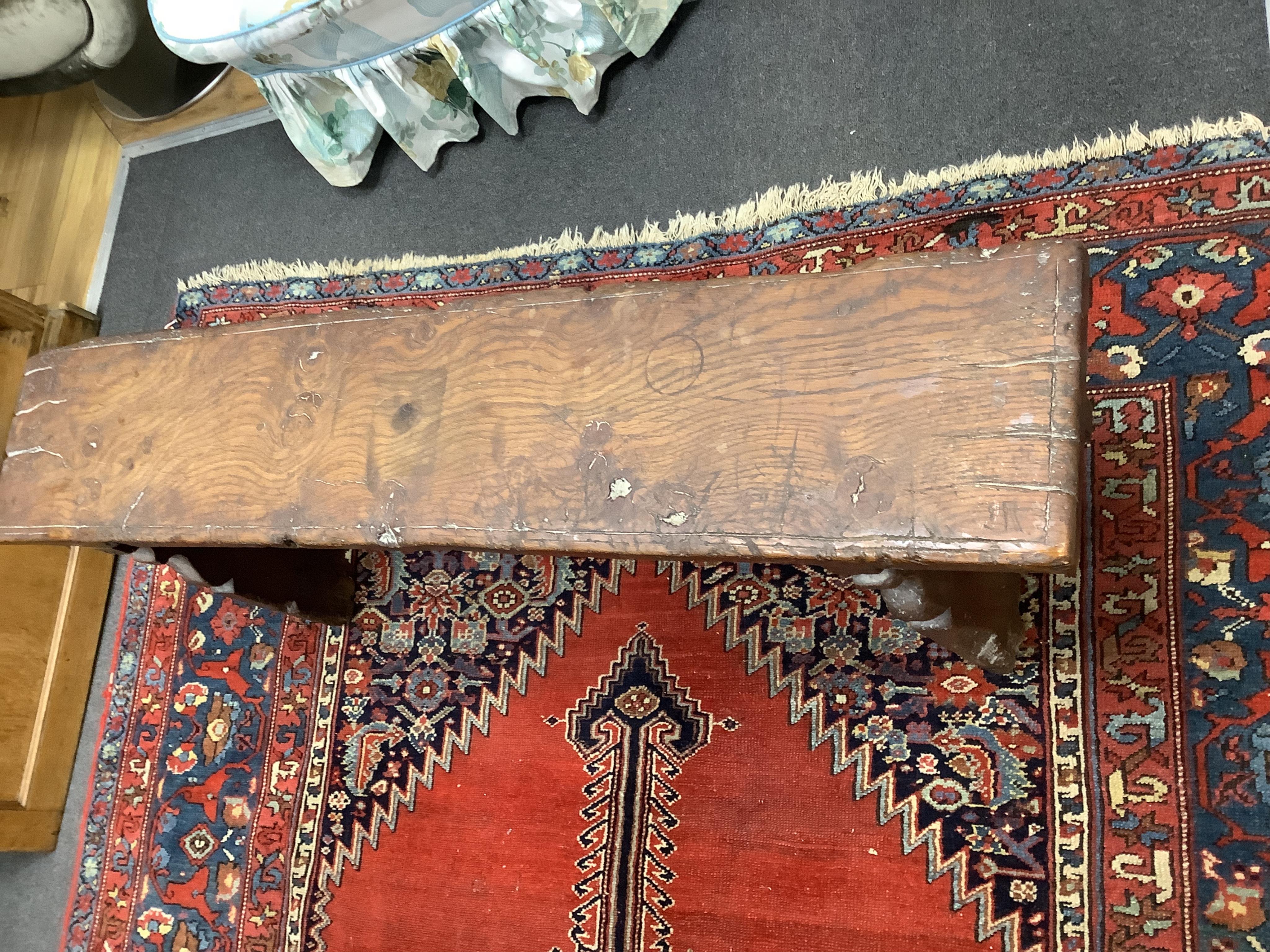 An oak trestle end bench, in Elizabethan style, width 121cm, depth 24cm, height 49cm. Condition - poor to fair, Provenance - made for Brede Place, Brede, Rye, East Sussex. Commissioned from Stuart interiors who have furn